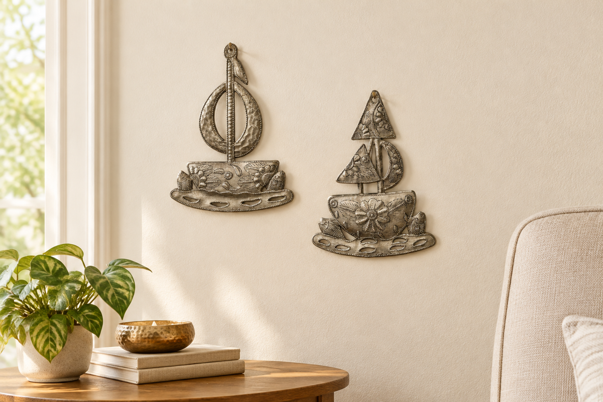 Going Sailing set of two Haitian metal sailboats on a living room wall