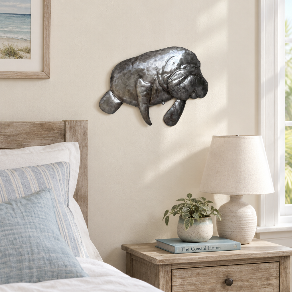 Haitian recycled steel manatee wall art in a coastal guest bedroom