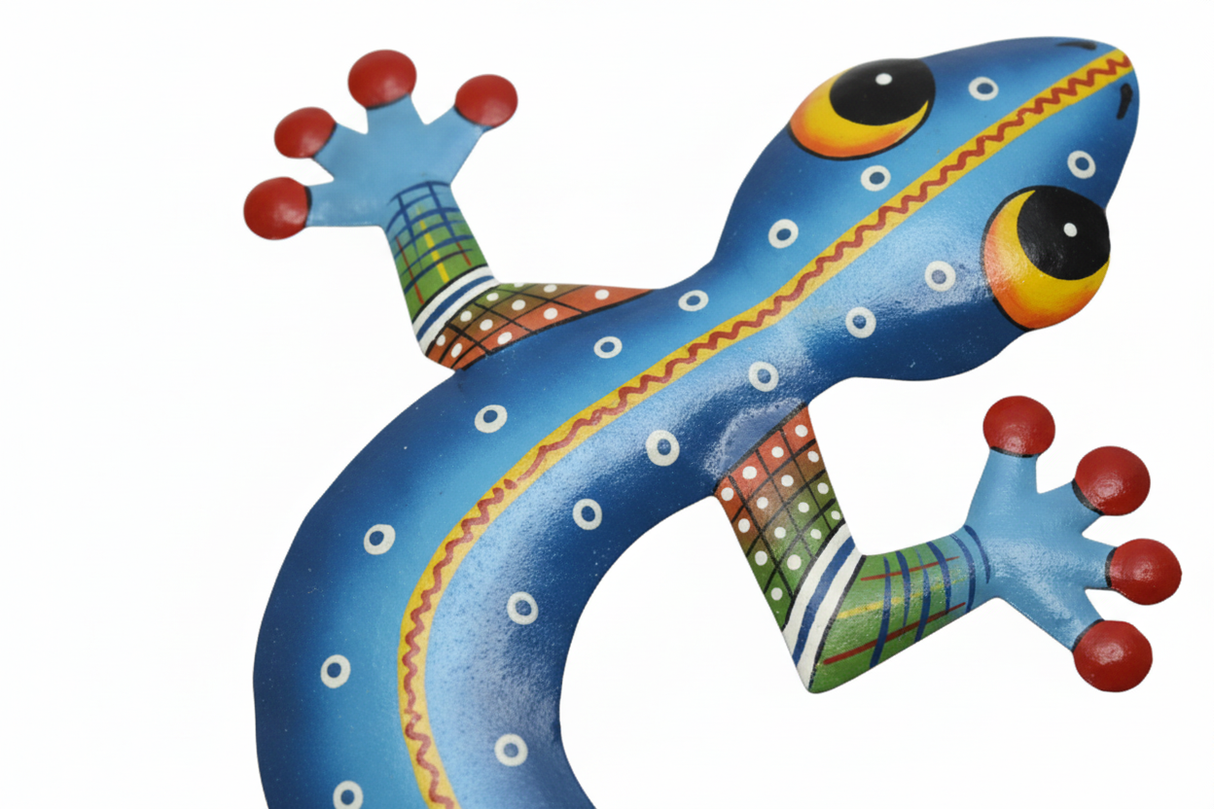 Close-up of hand-painted cobalt blue metal gecko showing white dot patterns, yellow zigzag stripe and red-tipped feet