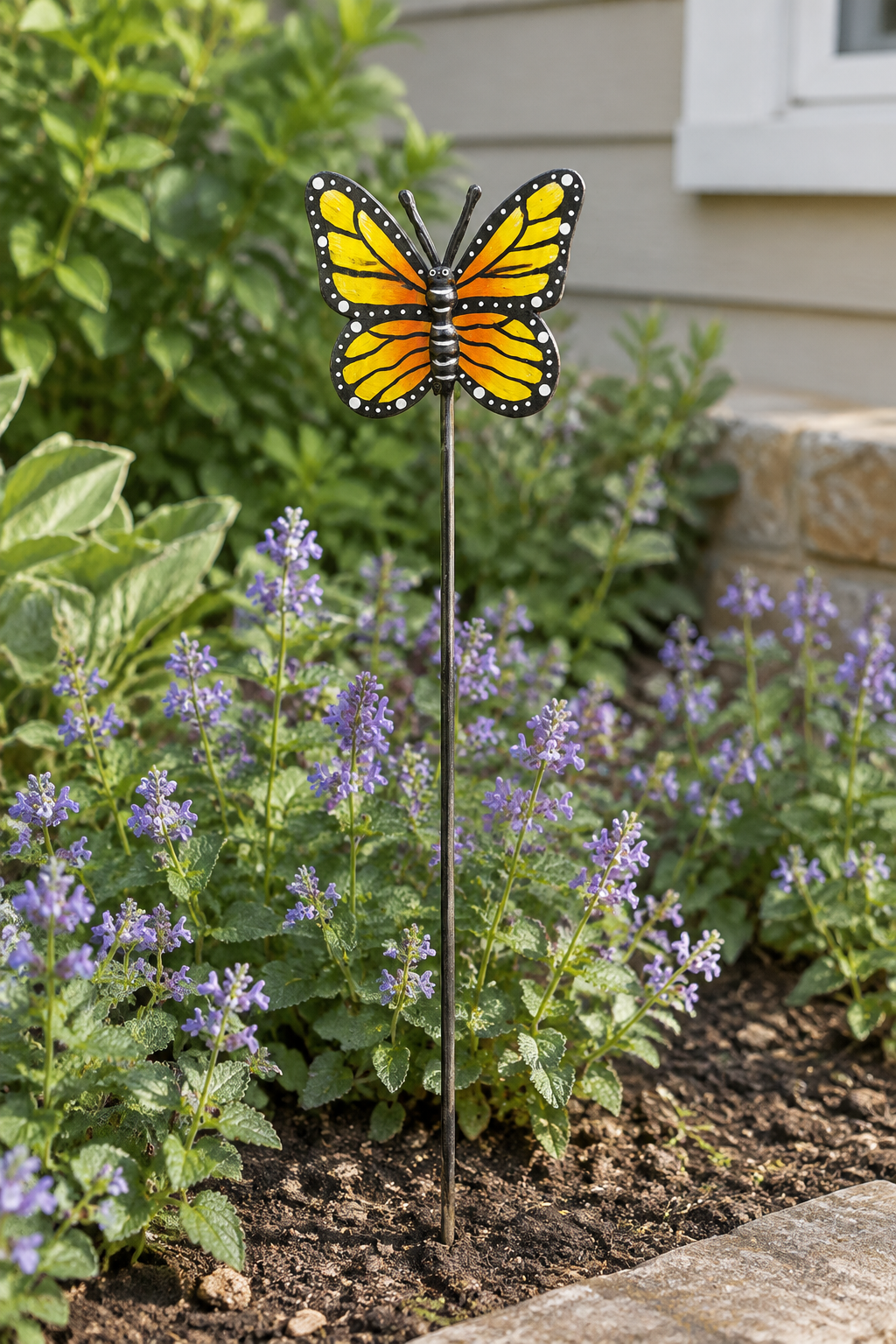 Espwa yellow butterfly garden stake in a flower bed