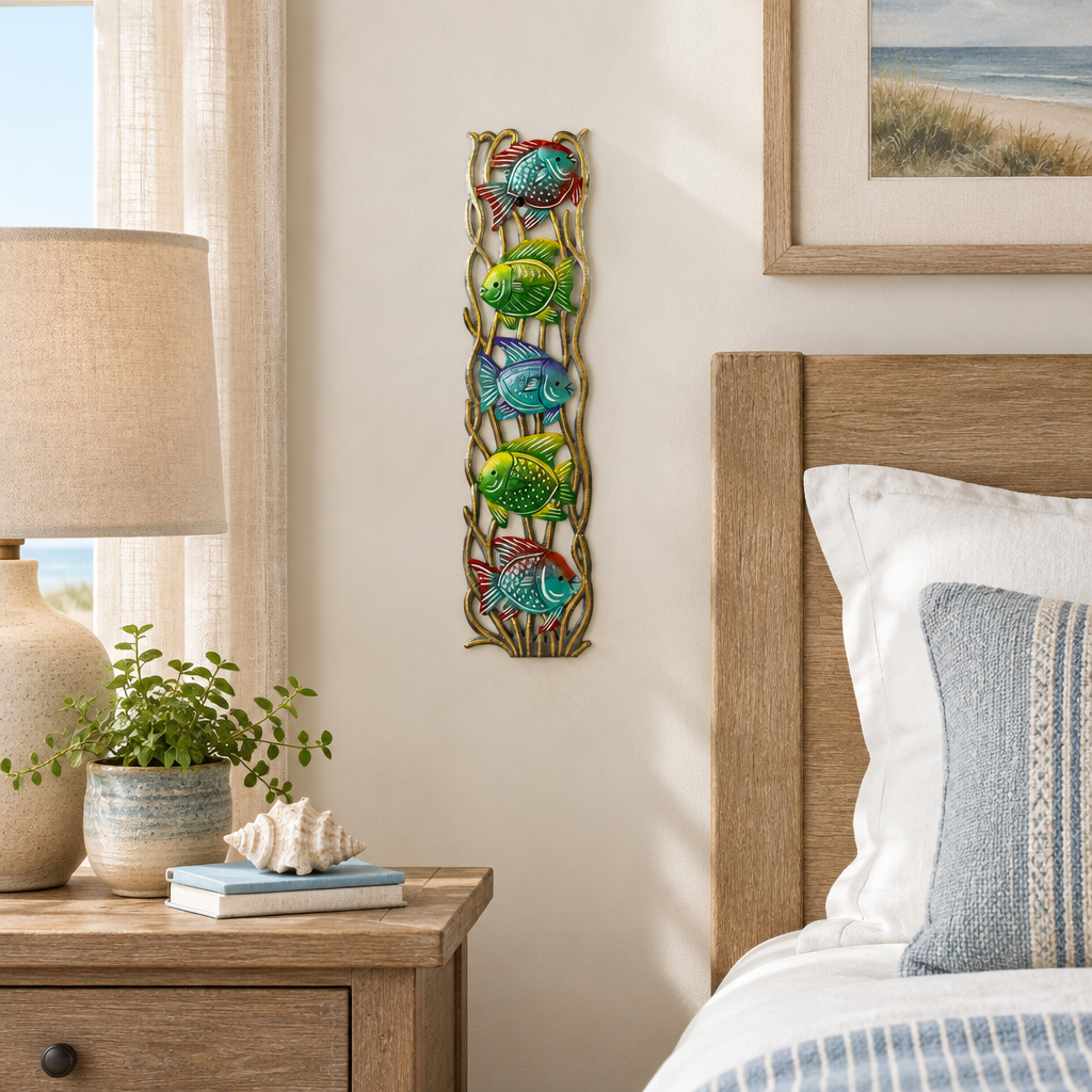 Handpainted Haitian stacked tropical fish metal wall art in a coastal guest bedroom