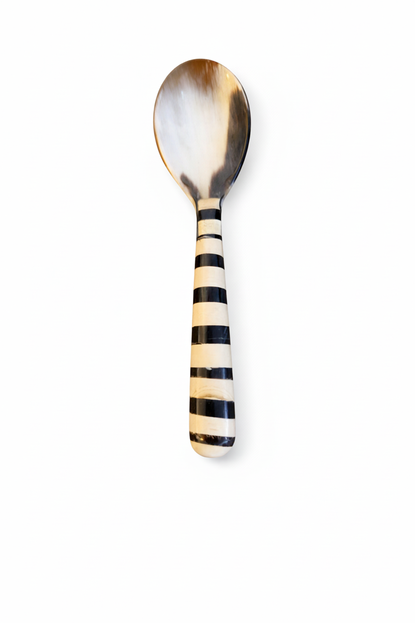 Handmade Haitian striped black and white horn and bone serving spoon on white background