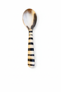 Handmade Haitian striped black and white horn and bone serving spoon on white background