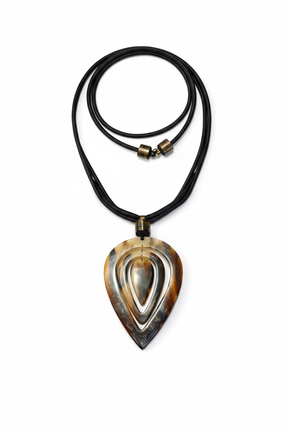Handmade Haitian ox horn teardrop pendant necklace with concentric carved design on black leather cord white background