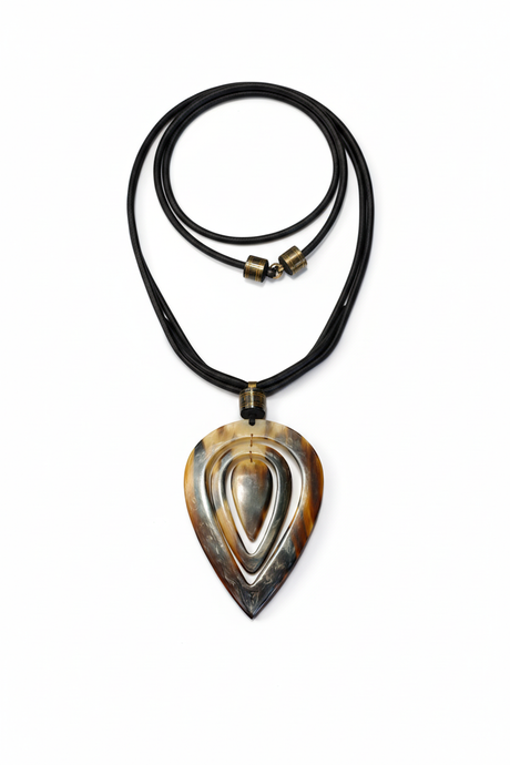 Handmade Haitian ox horn teardrop pendant necklace with concentric carved design on black leather cord white background