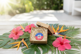 Haiti flag keychain in gift box with tropical flowers – gift presentation