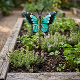 Handcrafted steel butterfly garden stake among herbs