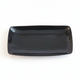 Handmade Haitian black ox horn serving tray with deep ebony gloss finish on white background