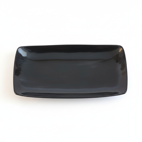 Handmade Haitian black ox horn serving tray with deep ebony gloss finish on white background