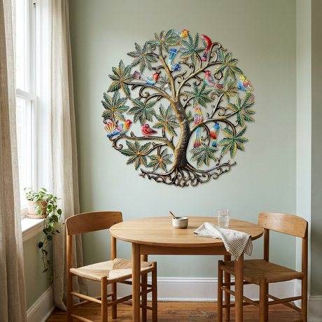Colorful birds and green leaves in steel drum tree wall art on a sage dining room wall.