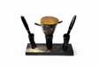 Handmade Haitian ox horn desk pen and inkwell stand with dual pen holders and amber lid on white background
