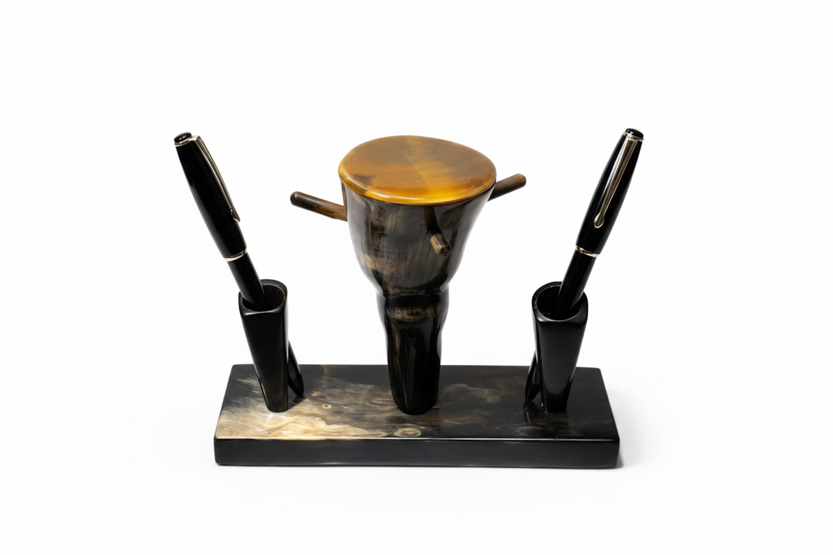 Handmade Haitian ox horn desk pen and inkwell stand with dual pen holders and amber lid on white background