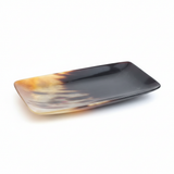 Handmade Haitian ox horn serving tray with natural tortoiseshell pattern on white background