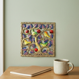 Handmade Haitian bird metal wall art above an oak office desk