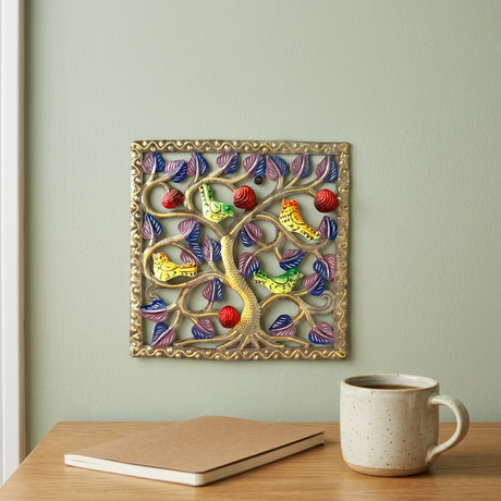 Handmade Haitian bird metal wall art above an oak office desk