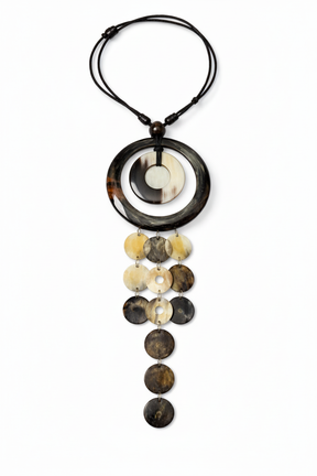 Handmade Haitian ox horn cascade disc necklace with ring frame and five graduated strands on white background