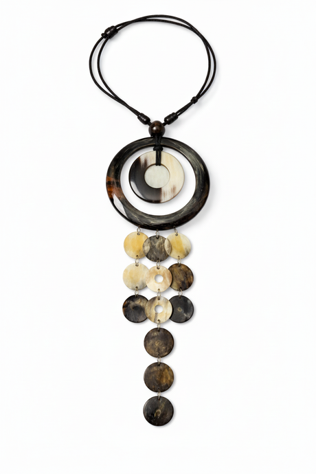 Handmade Haitian ox horn cascade disc necklace with ring frame and five graduated strands on white background