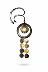 Handmade Haitian ox horn deep black ring frame with amber grey dome disc and three graduated disc cascade strands on white background