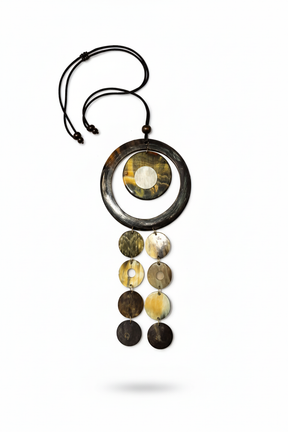 Handmade Haitian ox horn deep black ring frame with amber grey dome disc and three graduated disc cascade strands on white background