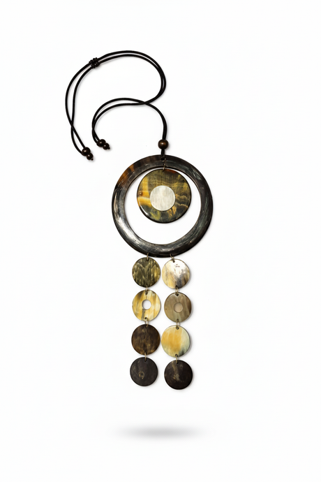 Handmade Haitian ox horn deep black ring frame with amber grey dome disc and three graduated disc cascade strands on white background