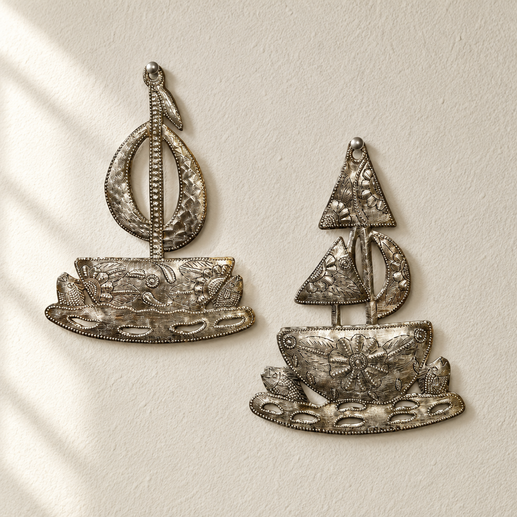 Close-up of two Going Sailing metal sailboats with textured floral hulls and openwork sails