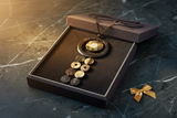 Haitian horn dark ring triple disc cascade necklace in luxury charcoal velvet gift box on dark marble with gold ribbon