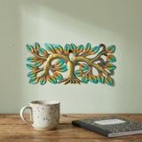 Handmade Haitian steel drum tree wall art above a wooden office desk