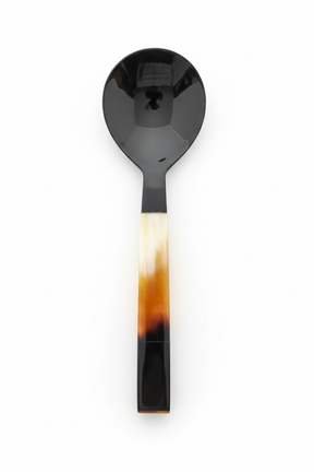 Handmade Haitian all-horn grand serving spoon with three-tone ivory amber black square handle on white background