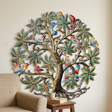 Recycled metal Birds Tree of Life wall art beside a reading chair.
