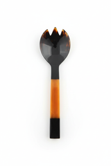 Handmade Haitian all-horn large salad fork with vivid amber and black square handle on white background