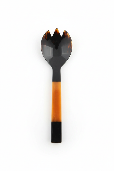 Handmade Haitian all-horn large salad fork with vivid amber and black square handle on white background