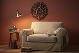 Haitian Tree of Life metal art on a terracotta accent wall in a cozy reading nook with linen armchair