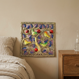 Small square metal bird artwork beside a wooden bedroom nightstand