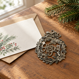 Handmade Haitian Hope metal Christmas ornament beside a holiday card