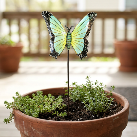 Light green butterfly garden stake in a terracotta porch planter