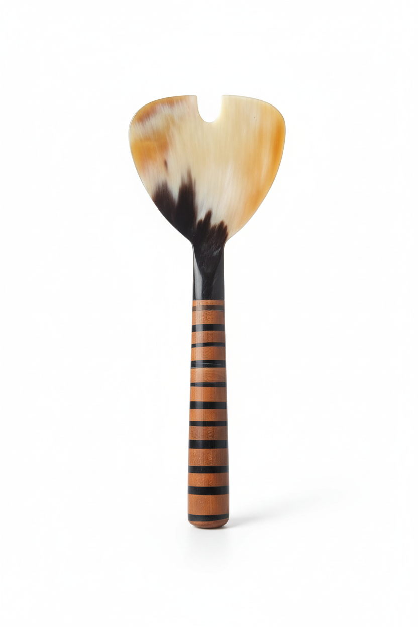 Handmade Haitian amber ivory ox horn and striped wood cheese knife spreader on white background