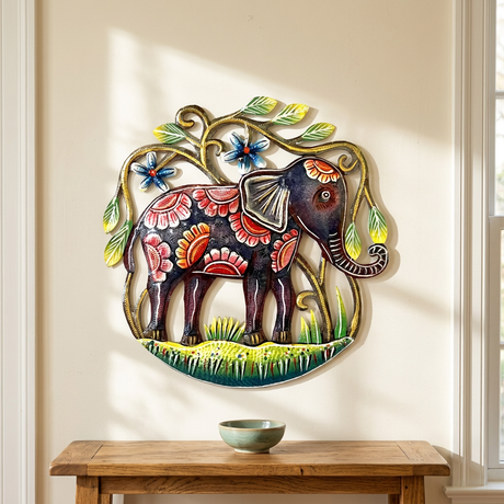 Colorful Haitian elephant metal wall art above an oak entryway console