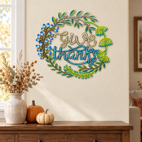 Handpainted Haitian Give Thanks metal wall art above a Thanksgiving sideboard