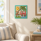Handpainted Haitian flamingo and palm tree metal wall art beside a living room armchair