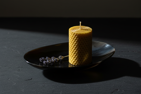 Haitian oval black horn dish with beeswax candle and dried lavender on dark slate surface