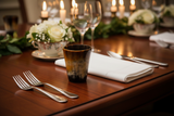 Haitian horn goblet cup on luxury dining table beside linen napkin silverware and floral centerpiece