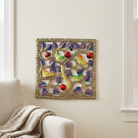 Colorful square bird and red fruit metal wall art beside a linen armchair
