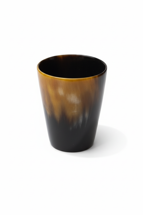 Handmade Haitian ox horn drinking cup tumbler with amber to black gradient on white background
