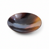 Handmade Haitian deep round ox horn bowl with mahogany tortoiseshell pattern on white background