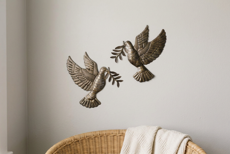 Dove and olive branch metal wall art pair in a quiet reading nook