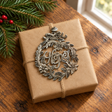 Handmade Haitian Hope metal Christmas ornament on a kraft-wrapped gift
