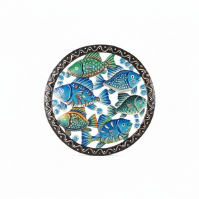 Handcrafted Haitian metal circular wall art featuring colorful tropical fish in blues, greens, and turquoise