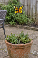 Espwa yellow butterfly garden stake in a terracotta patio planter