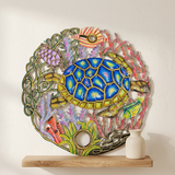 Blue sea turtle, fish, and coral details in painted Haitian steel drum wall art.
