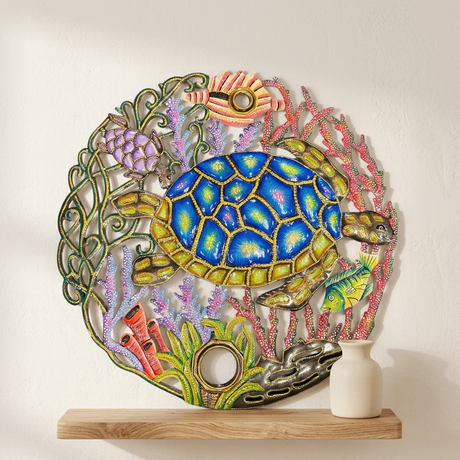 Blue sea turtle, fish, and coral details in painted Haitian steel drum wall art.